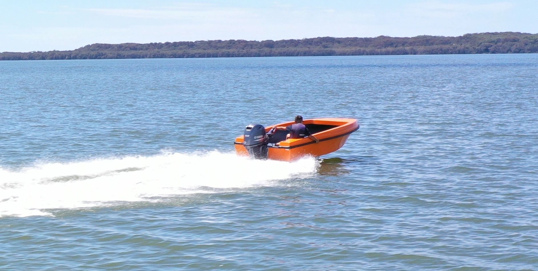 Orange Mighty Boy at speed, side on